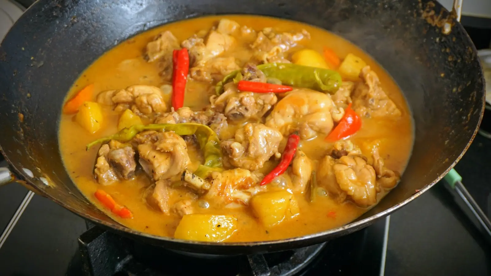 Chicken curry in coconut cream in wok