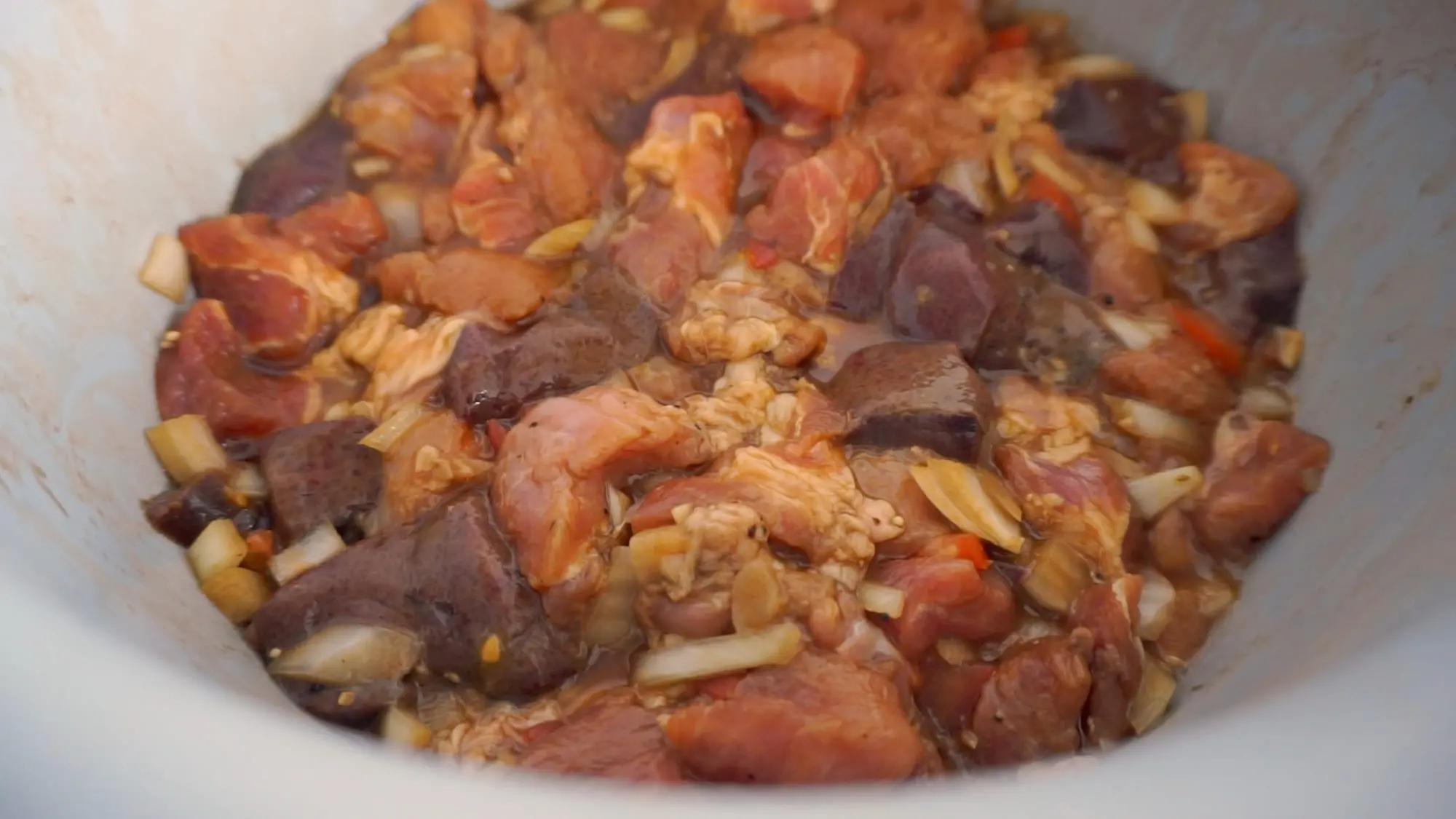 Pork and liver marinating with onion, garlic, soy sauce, and calamansi