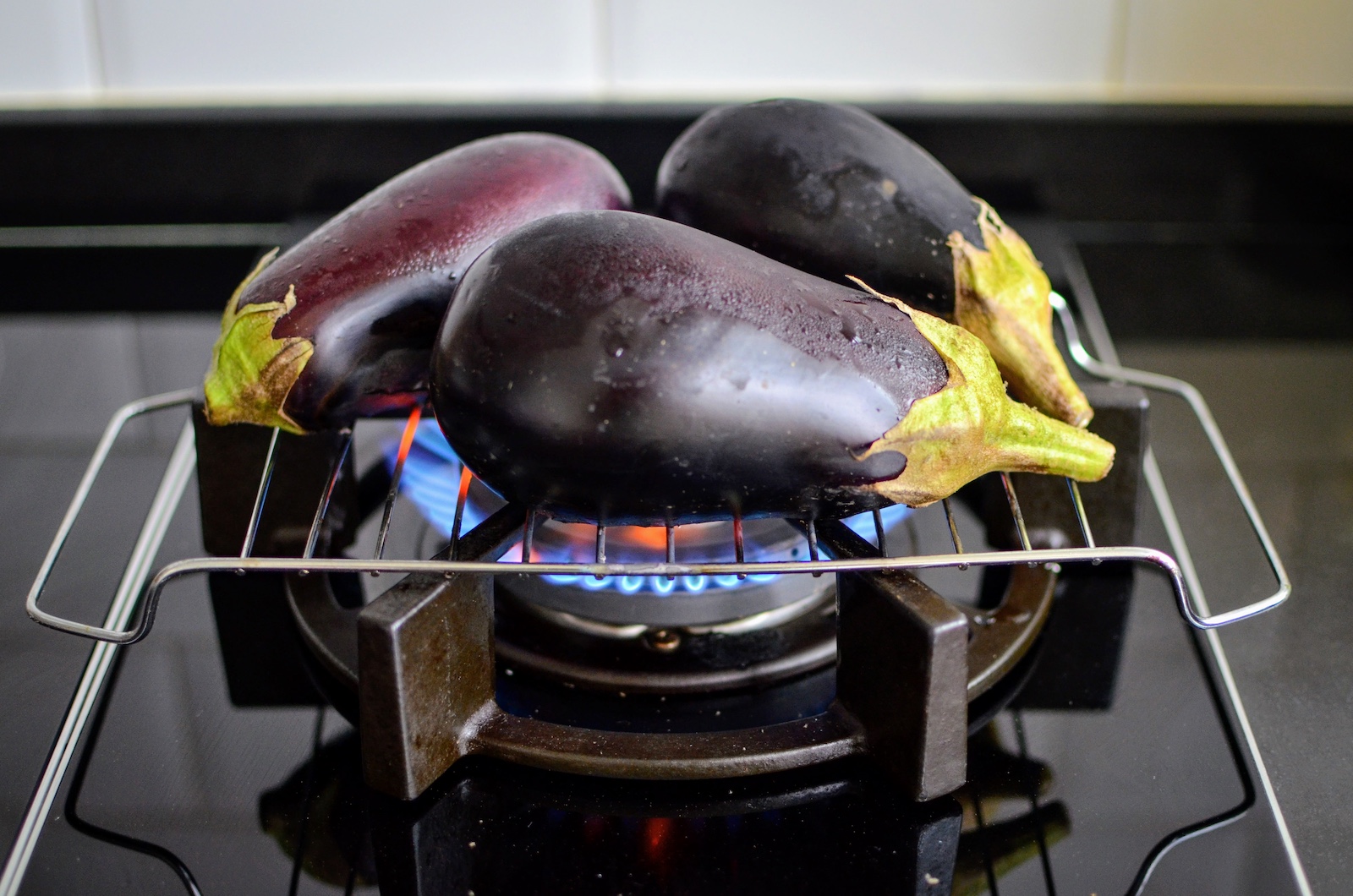Fresh eggplants on a stove in a Filipino kitchen