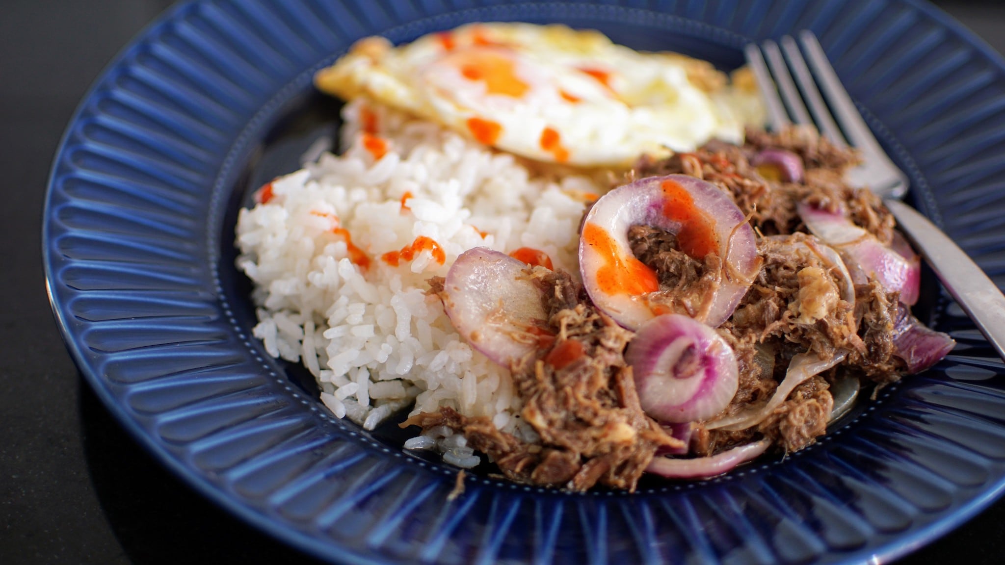 Corned beef, sunny-side up fried egg and rice