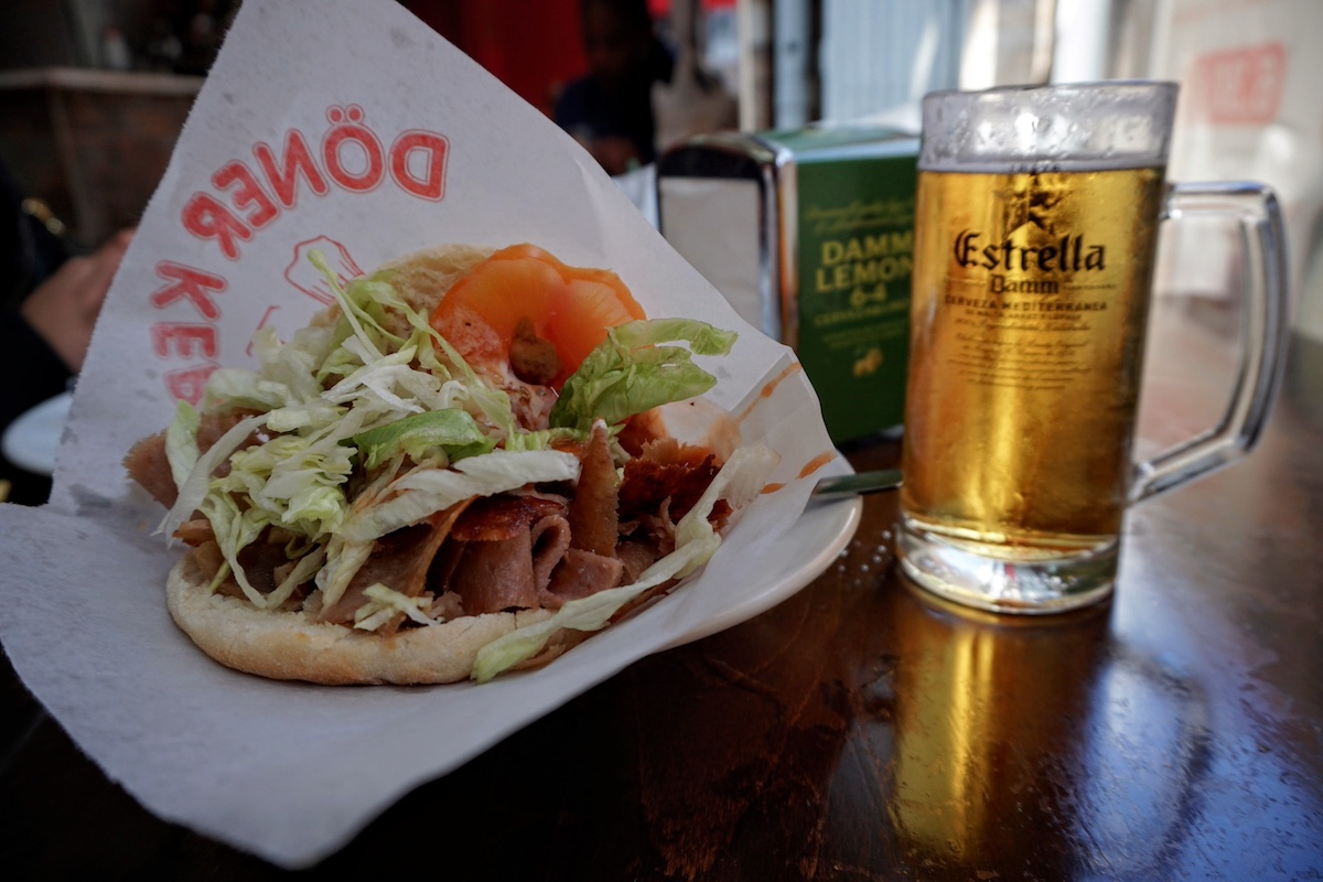 Döner kebab sandwich and a mug of cold beer